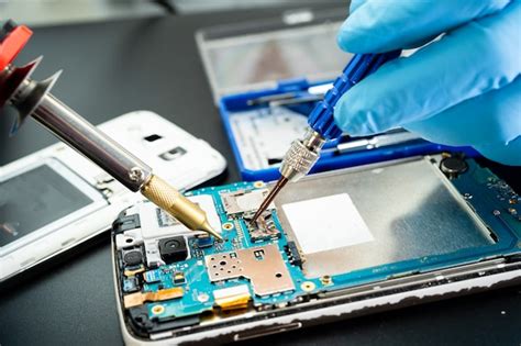Premium Photo Technician Repairing Inside Of Mobile Phone By Premium Photo Technician Repairing Inside Of Mobile Phone By